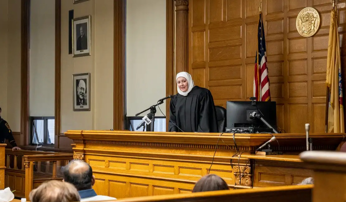 A real judge delivering the final verdict on is Batman a vigilante or hero.